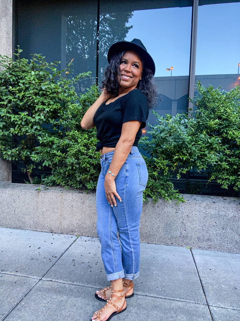 black v-neck tee and jeans and hat